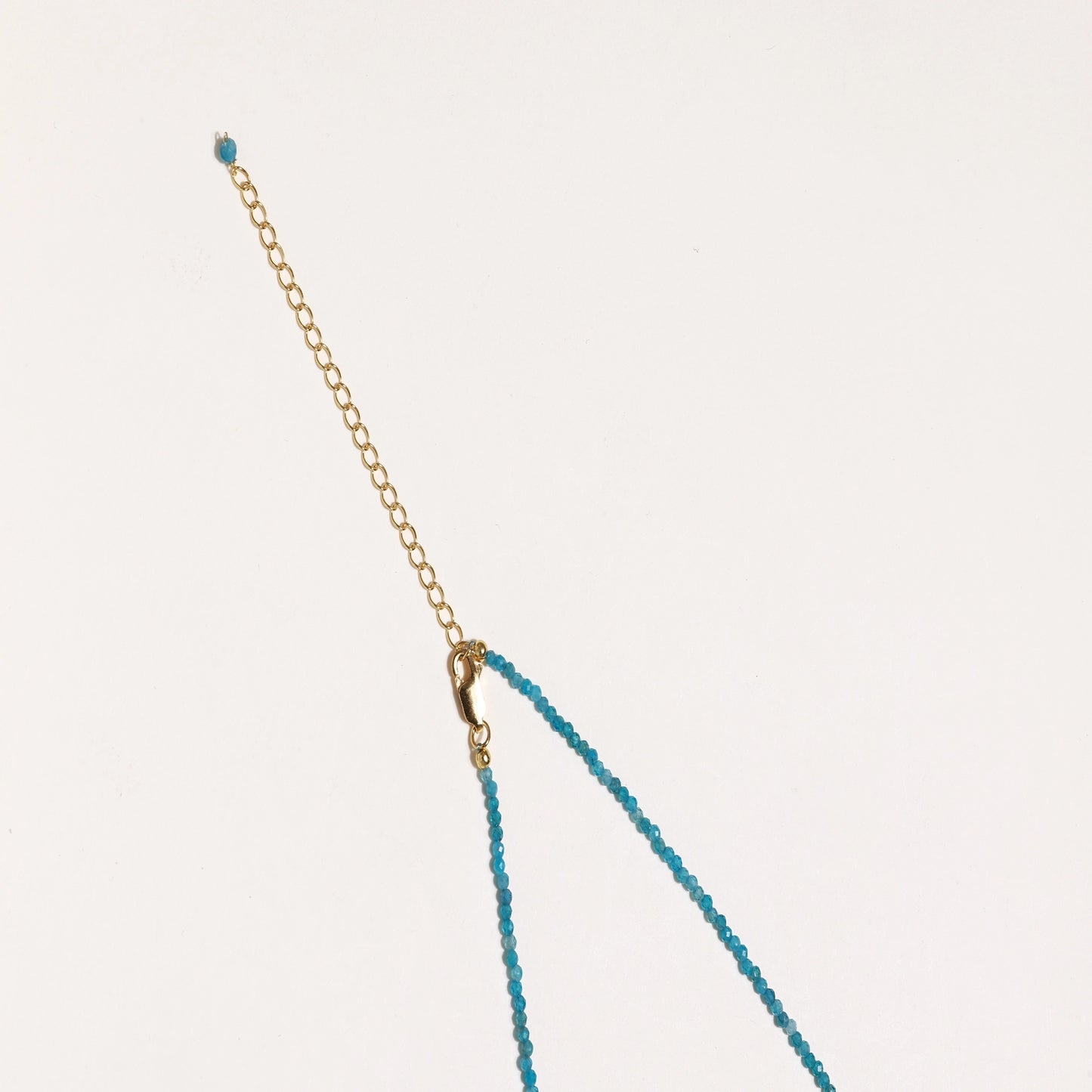 Delicate necklace featuring small turquoise apatite beads with a central freshwater pearl on sterling silver chain