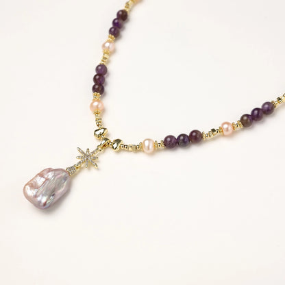 Gold-plated necklace with purple amethyst beads, pink pearls, and iridescent baroque pearl pendant beneath crystal star charm