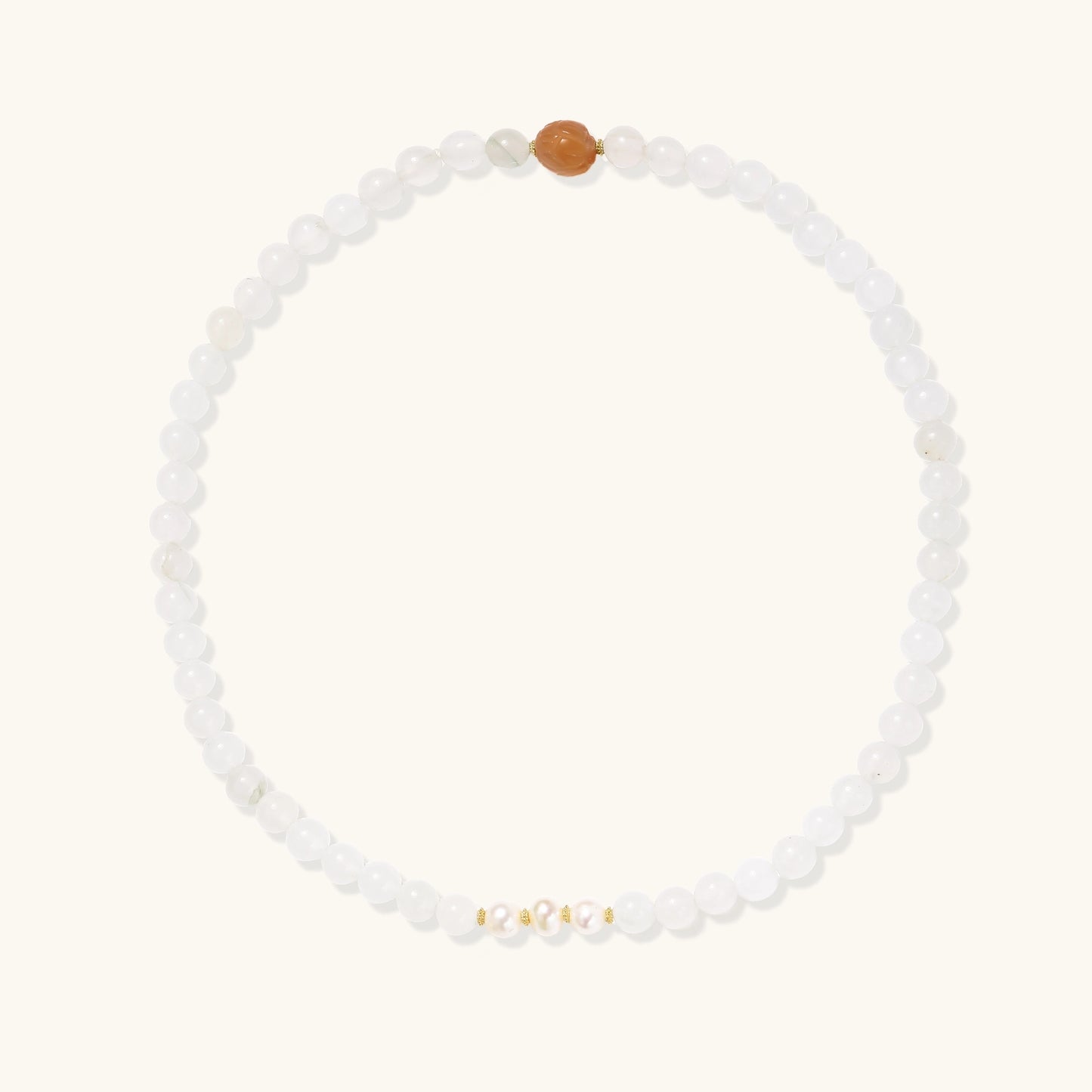 Stretch bracelet with white jade beads, freshwater pearls, and orange agate centerpiece on cream background.