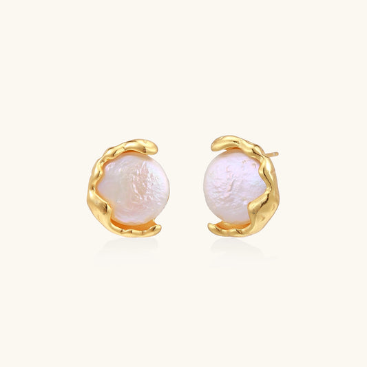 Gold-plated sterling silver stud earrings with organic claw settings cradling lustrous freshwater pearls on white background.