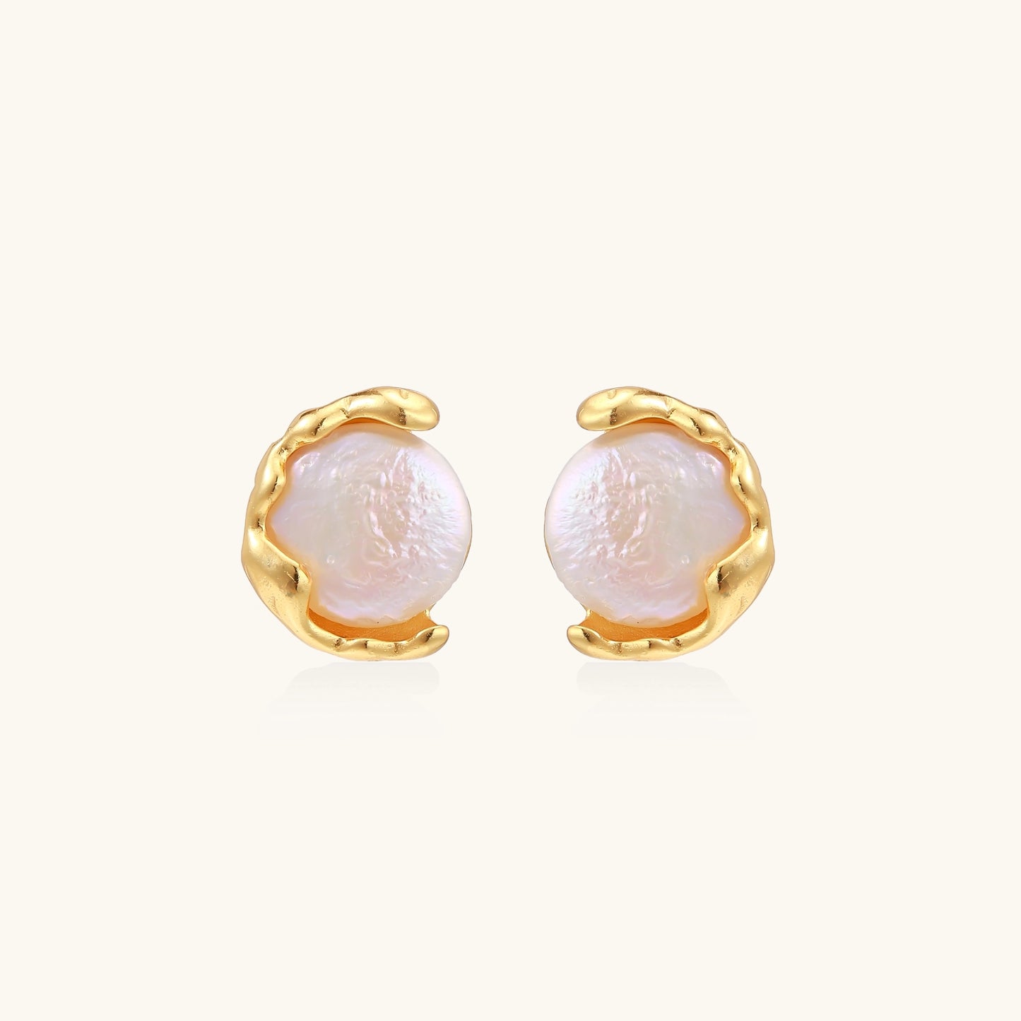 Gold-plated sterling silver stud earrings with organic claw settings cradling lustrous freshwater pearls on white background.