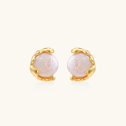 Gold-plated sterling silver stud earrings with organic claw settings cradling lustrous freshwater pearls on white background.