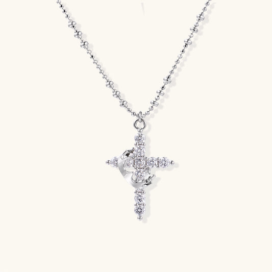Close-up of 18K gold plated cross necklace with zirconia crystals arranged in cross pattern on ball chain