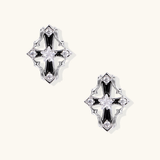 Pair of gold-plated cross earrings with clear zirconia crystals and silver posts on neutral background.