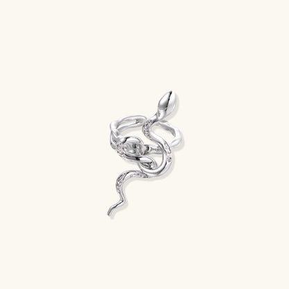 Gold-plated brass snake ring with flowing curves and crystal accents, wrapping around finger in sculptural design
