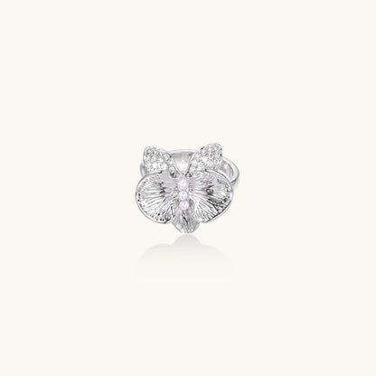 Gold-plated brass ring with textured orchid petals, zirconia stones, and center pearls on white background.