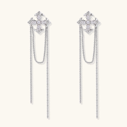 Ornate gold-plated cross earrings with zirconia crystals and flowing chain details on white background