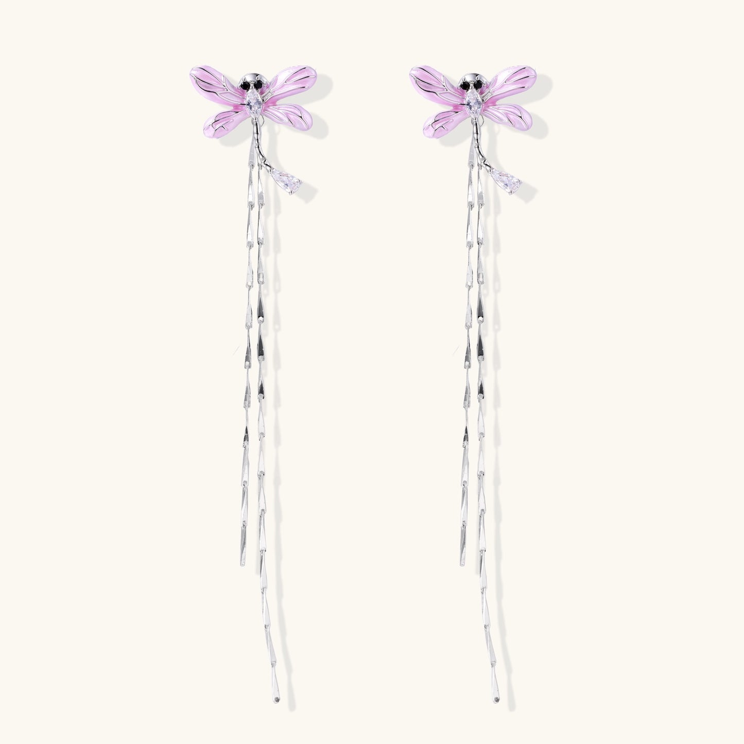 Long dangle earrings with purple dragonfly charms and crystal chains on white background, gold-plated finish.