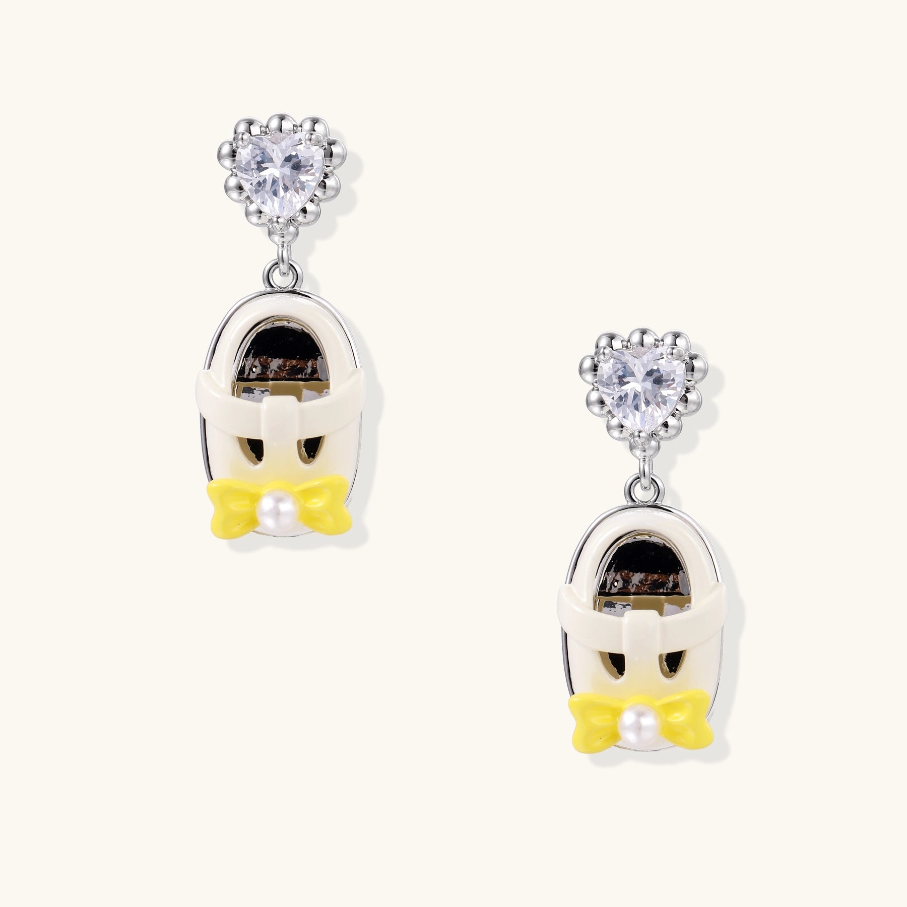18K gold plated drop earrings with heart-shaped zirconia studs and translucent mini handbag pendants with pearl accents