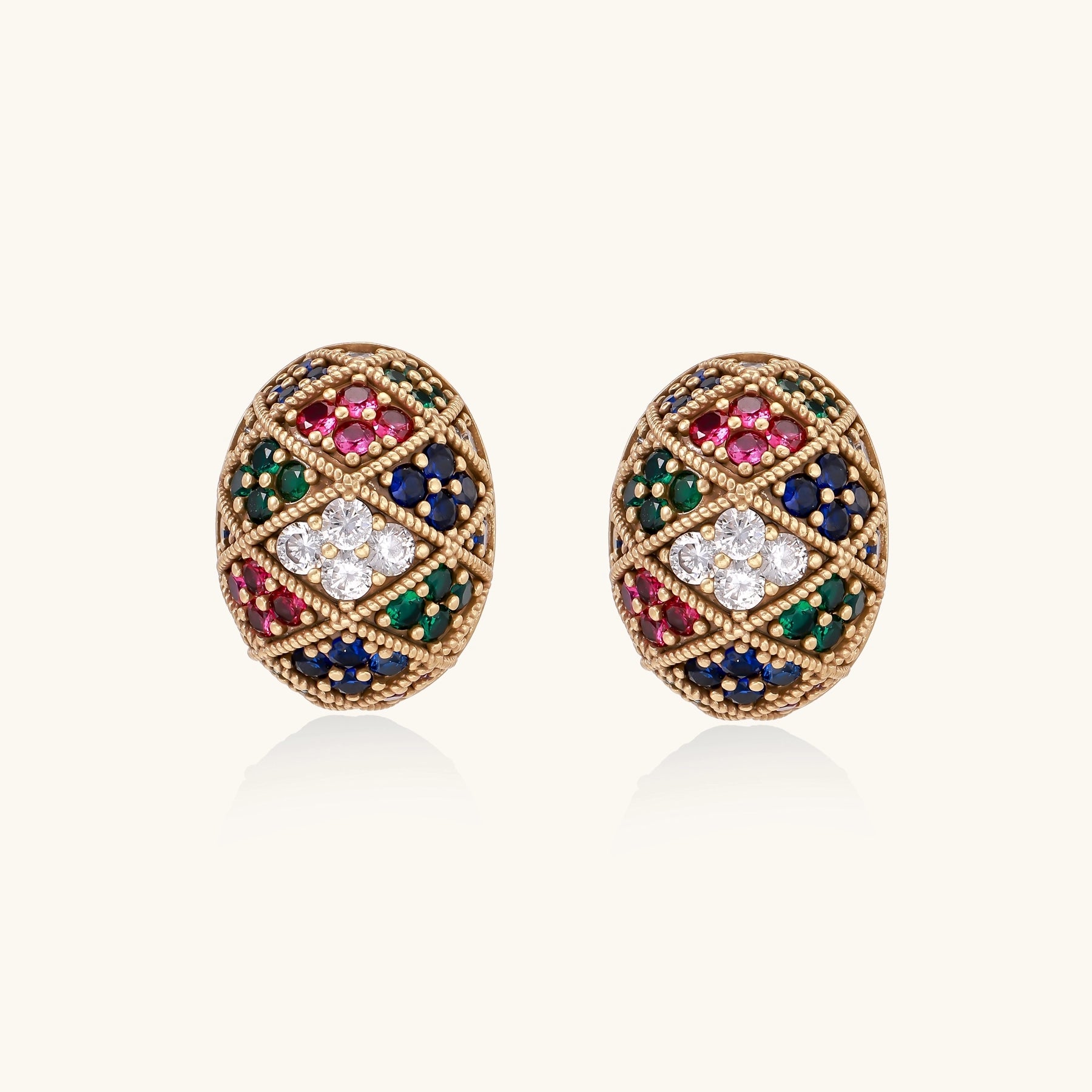 Oval gold-plated stud earrings with multicolor zirconia stones in geometric diamond pattern on white background.