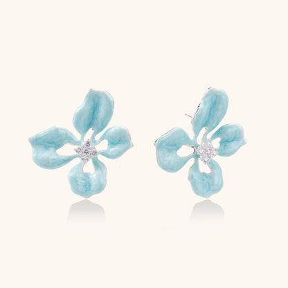 Turquoise blue enamel flower earrings with crystal centers and gold-plated brass posts on white background.