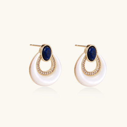 Gold-plated drop earrings featuring blue lapis lazuli ovals, diamond-studded circles, and iridescent mother of pearl teardrops