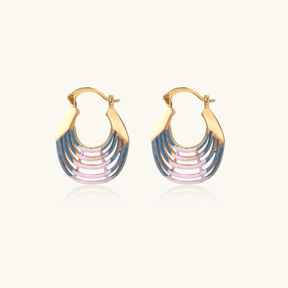 Gold hoop earrings with layered blue to pink enamel in shell pattern, photographed against white background