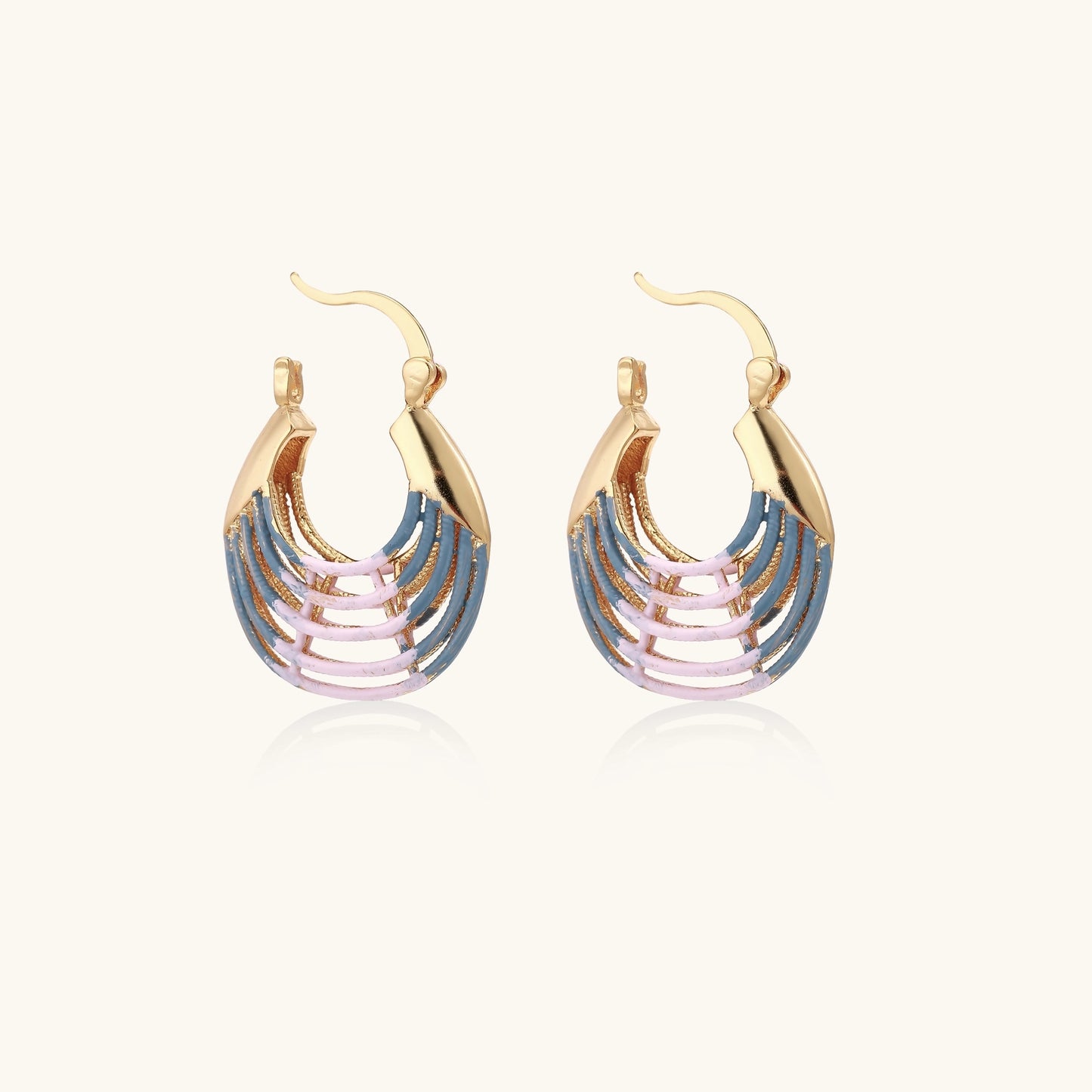 Gold hoop earrings with layered blue to pink enamel in shell pattern, photographed against white background