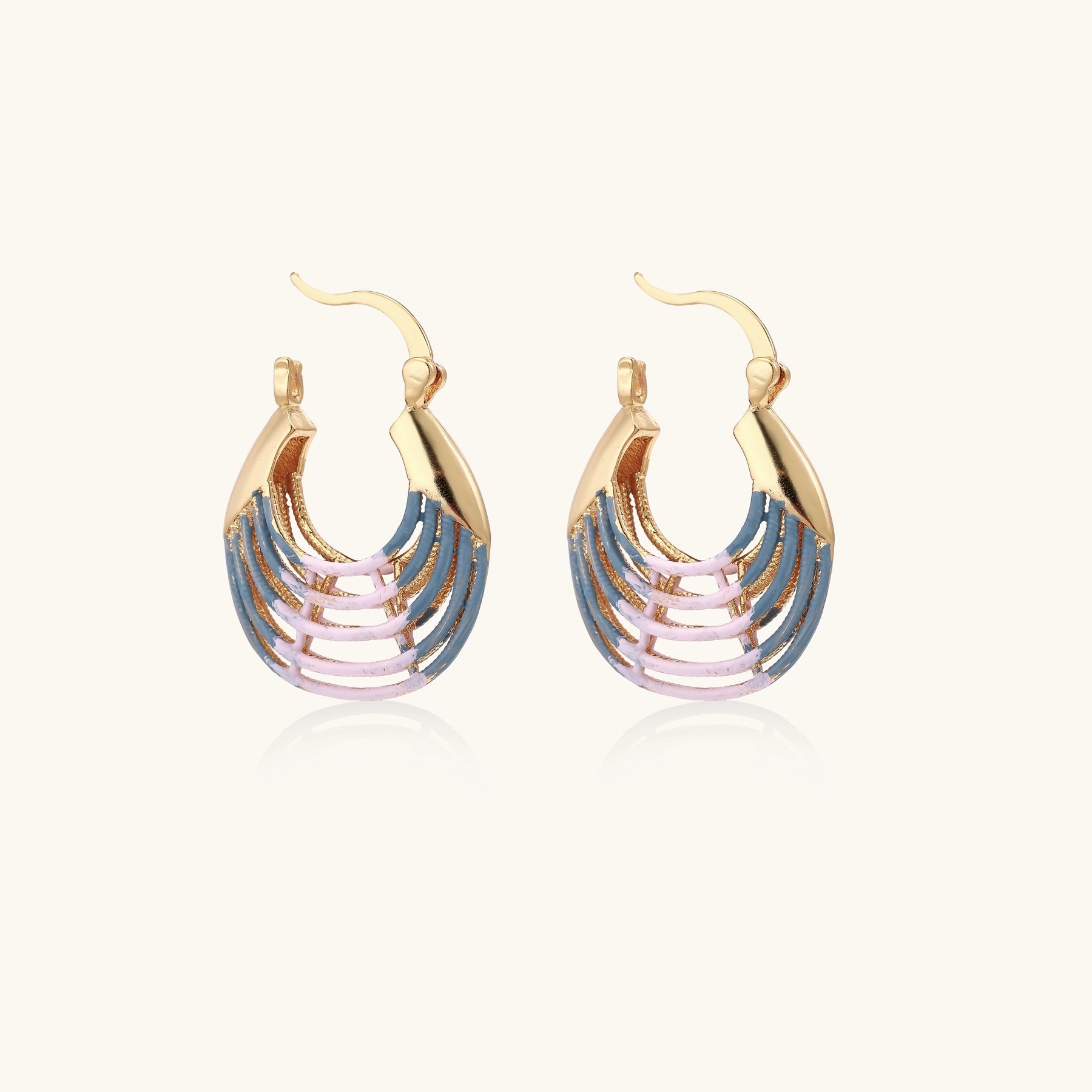 Gold hoop earrings with layered blue to pink enamel in shell pattern, photographed against white background