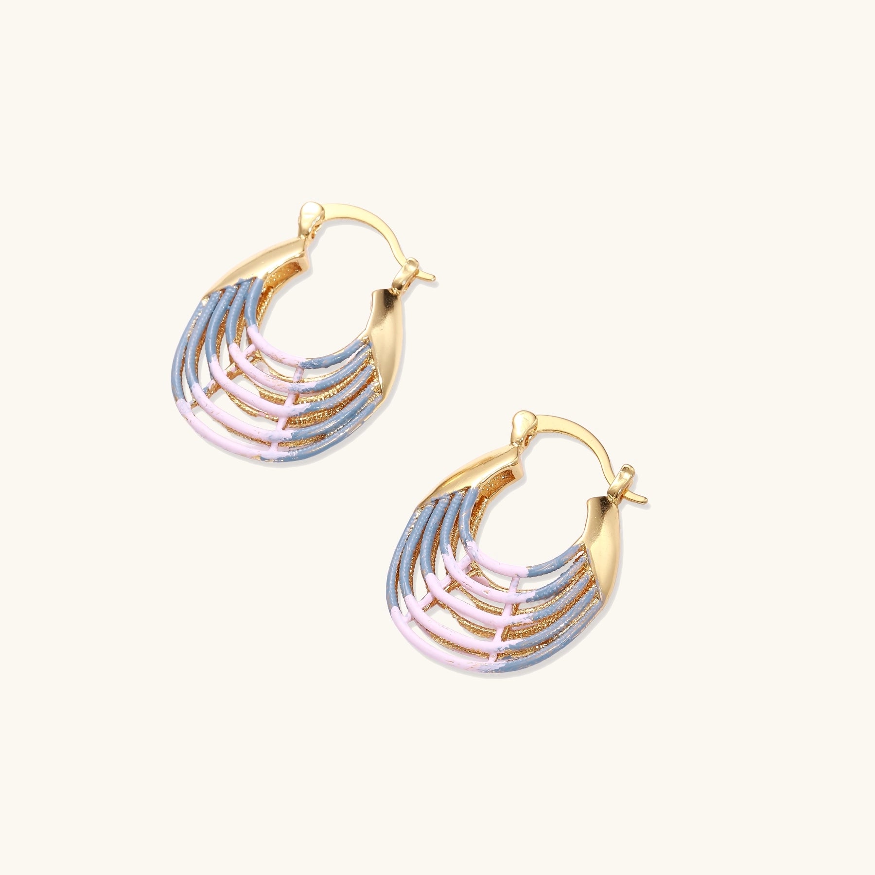 Gold hoop earrings with layered blue to pink enamel in shell pattern, photographed against white background