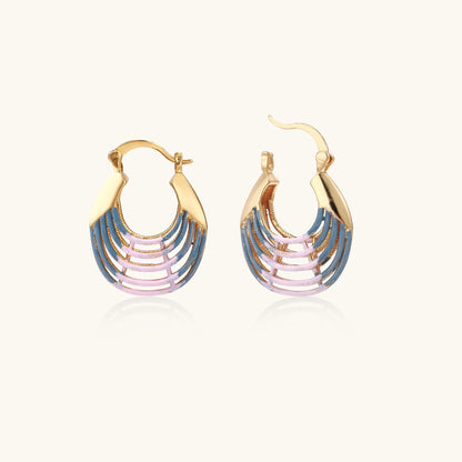 Gold hoop earrings with layered blue to pink enamel in shell pattern, photographed against white background
