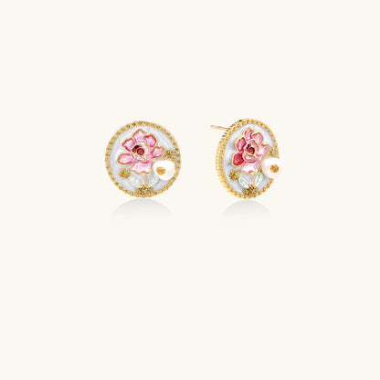 Round gold-plated stud earrings featuring pink enamel roses with freshwater pearl accents on white background.