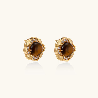 Ornate gold-plated brass stud earrings featuring round tiger's eye stones surrounded by sparkling zirconia in floral design