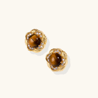 Ornate gold-plated brass stud earrings featuring round tiger's eye stones surrounded by sparkling zirconia in floral design