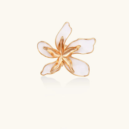 Gold-plated adjustable ring with large white enamel flower design featuring smooth petals outlined in gold