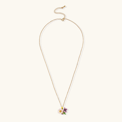 Delicate 18K gold plated necklace featuring colorful enamel flowers in pink and white with green leaves on chain