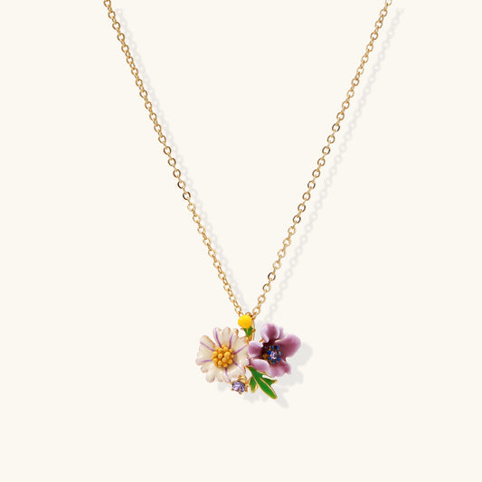 Delicate 18K gold plated necklace featuring colorful enamel flowers in pink and white with green leaves on chain