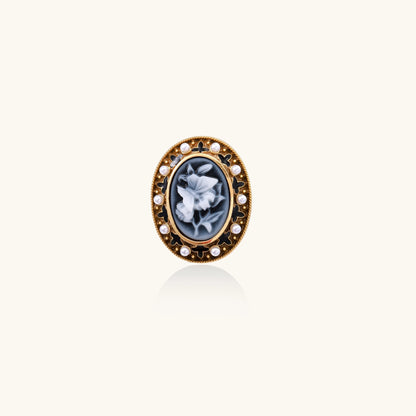 Oval cameo ring with blue-grey floral design surrounded by white shell pearls in gold-plated brass setting