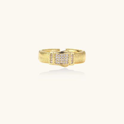 Gold-plated brass cuff ring with textured band and rectangular cubic zirconia centerpiece on cream background