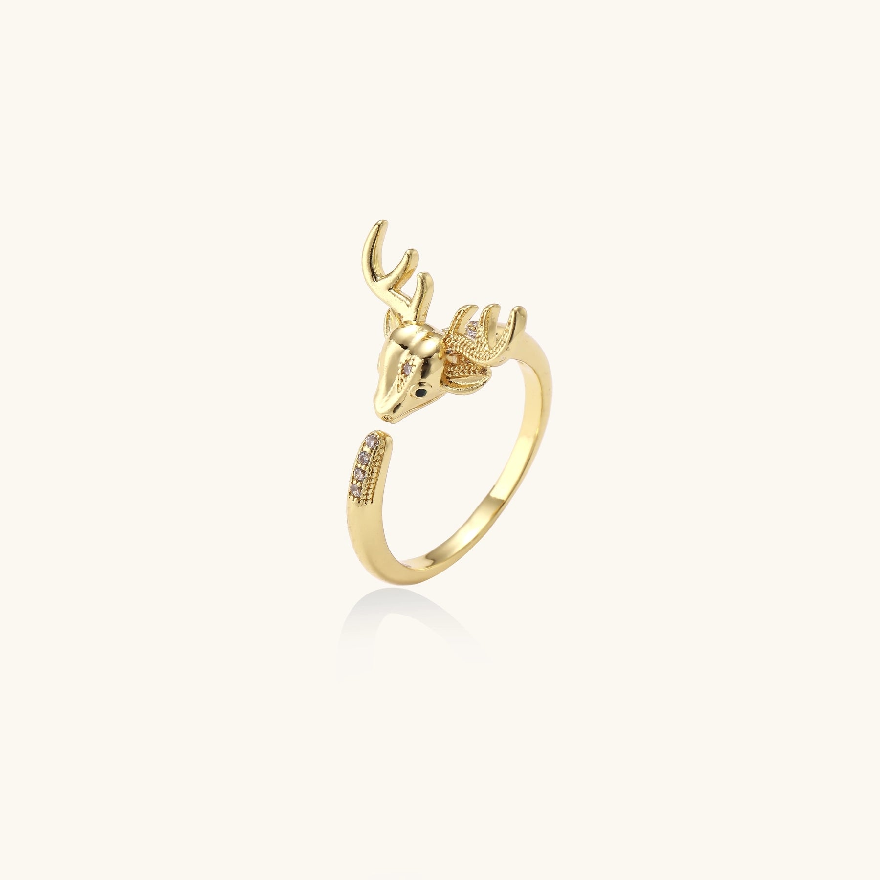 Gold-plated brass deer antler ring with cubic zirconia stones featuring detailed stag head design on white background.