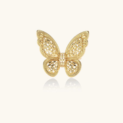 Adjustable gold-plated brass butterfly ring with intricate filigree cutout patterns and cubic zirconia accents on white background.