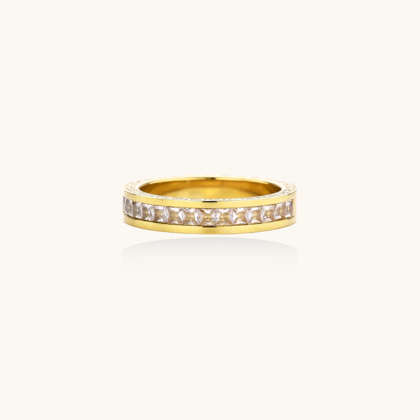 14K gold plated ring with channel-set zirconia stones and Greek key pattern engraved on sides on white background