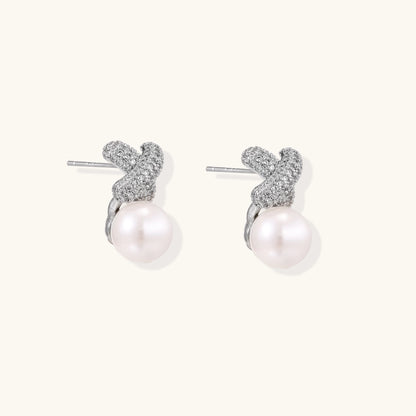Elegant drop earrings with pavé crystal cross tops and round freshwater pearls on 14K gold plated brass setting.