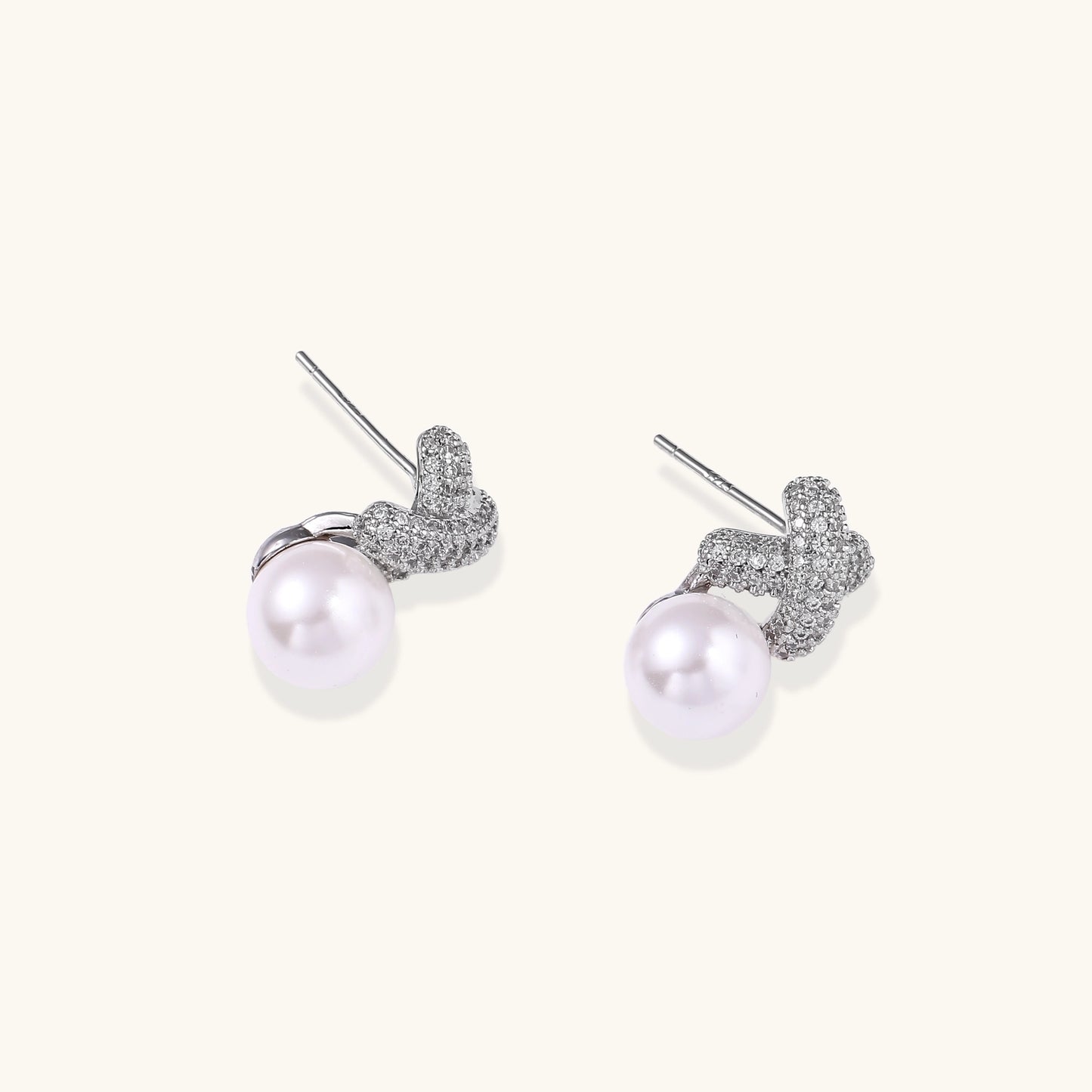 Elegant drop earrings with pavé crystal cross tops and round freshwater pearls on 14K gold plated brass setting.