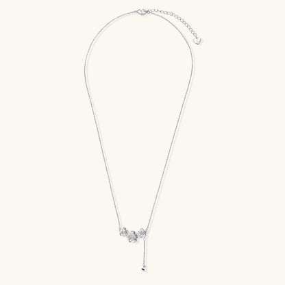 Delicate Y-style necklace with three textured flower pendants and adjustable chain in 14K gold plated brass finish.