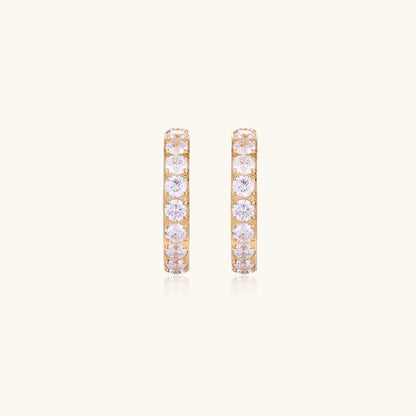 Gold-plated hoop earrings with crystal pavé and floating freshwater pearls inside the circular design.